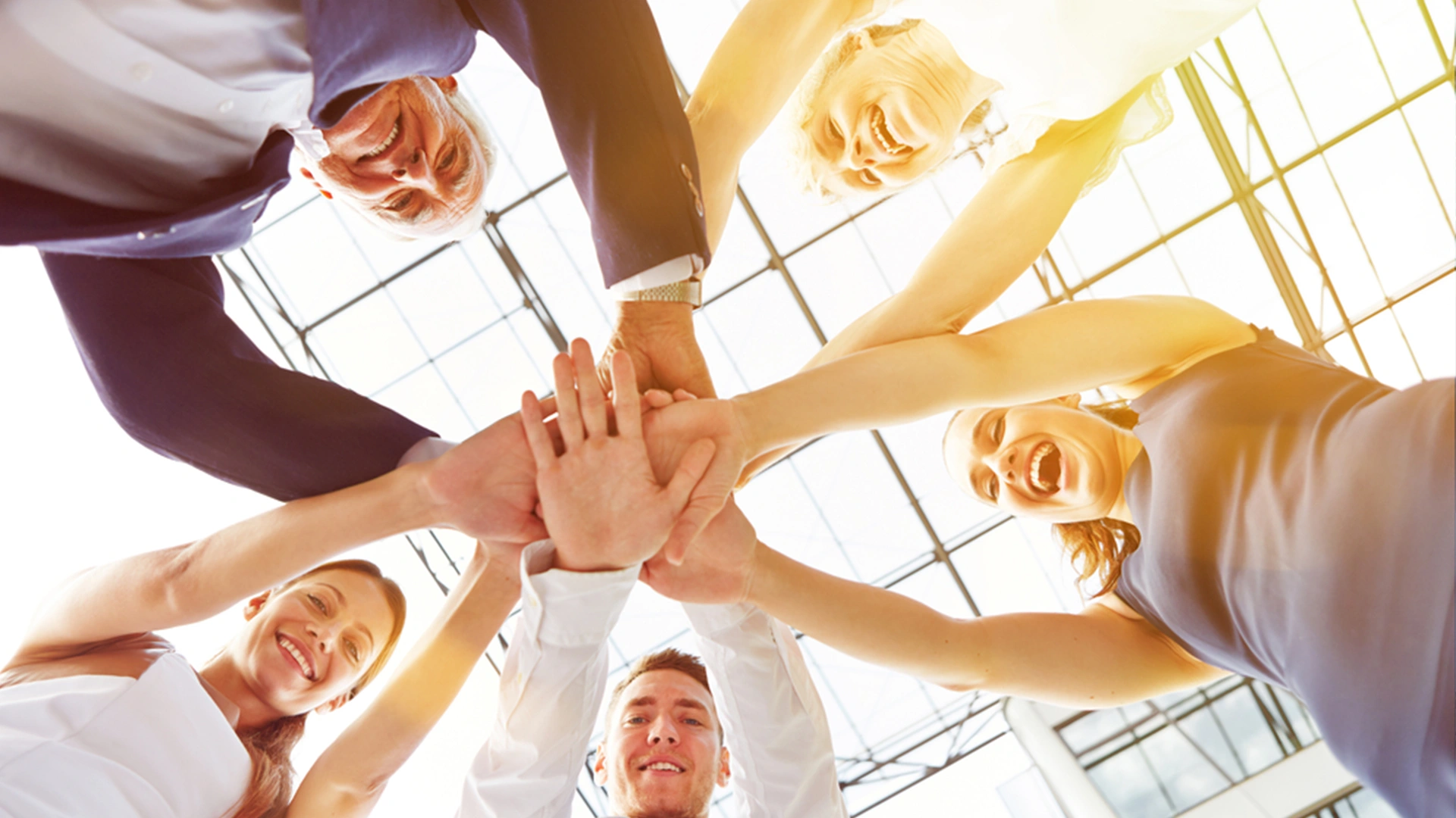 Stock photo of a group of people doing a group high-five.