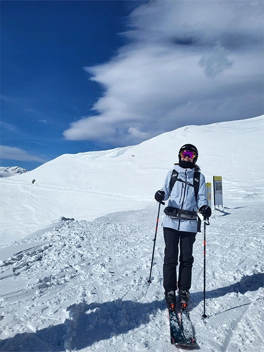 The image shows a person skiing in a snow-covered area