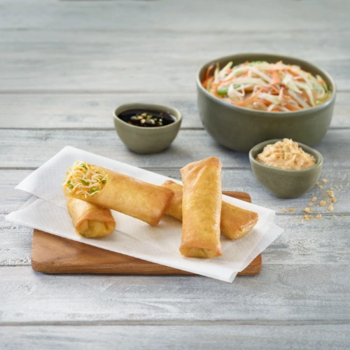 The image shows a product photo from KADI featuring beautifully presented spring rolls with side dishes.